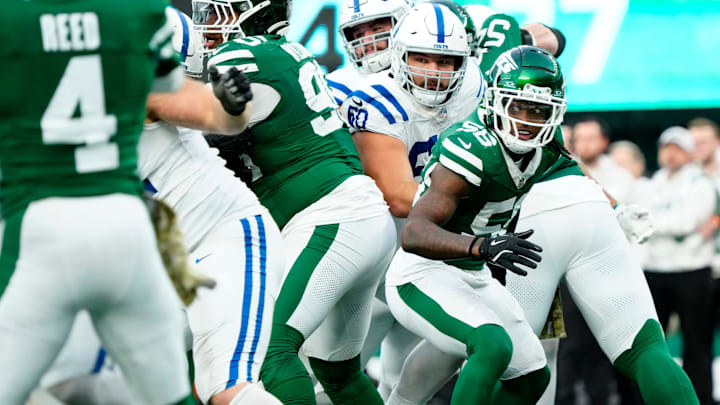 New York Jets linebacker Quincy Williams (56) and Indianapolis Colts guard Tanor Bortolini (60) try to keep their eyes on the ball, Sunday, November 17, 2024, during an exciting fourth quarter. New York Jets linebacker Quincy Williams (56) and Indianapolis Colts guard Tanor Bortolini (60) try to keep their eyes on the ball, Sunday, November 17, 2024, during an exciting fourth quarter.