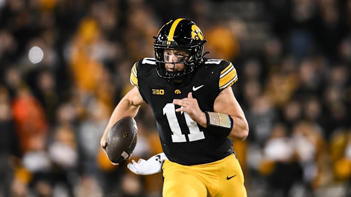 Nov 22, 2025; Iowa City, Iowa, USA; Iowa Hawkeyes quarterback Mark Gronowski (11) scrambles for yards against the Michigan State Spartans during the fourth quarter at Kinnick Stadium. Mandatory Credit: Jeffrey Becker-Imagn Images