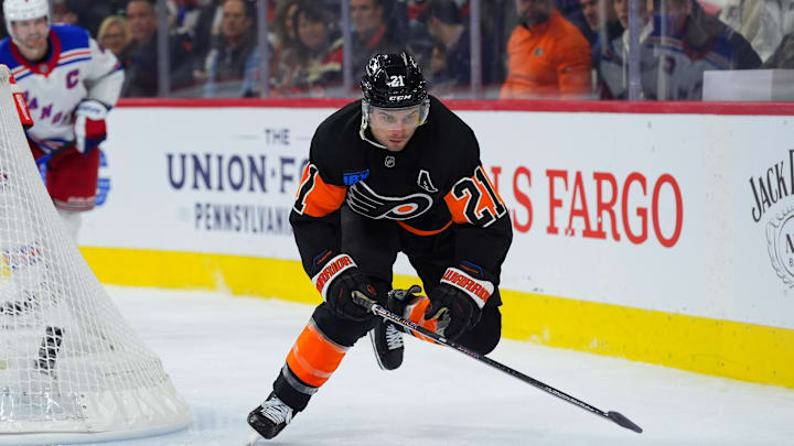 Nov 29, 2024; Philadelphia, Pennsylvania, USA; Philadelphia Flyers center Scott Laughton (21) reaches for the puck against the New York Rangers in the third period at Wells Fargo Center. Mandatory Credit: Kyle Ross-Imagn Images