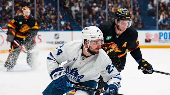 Jan 31, 2026; Vancouver, British Columbia, CAN; Vancouver Canucks defenseman Tyler Myers (57) defends against Toronto Maple Leafs forward Scott Laughton (24) in the third period at Rogers Arena. Mandatory Credit: Bob Frid-Imagn Images