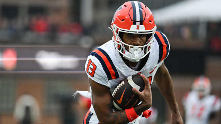 Oct 14, 2023; College Park, Maryland, USA; Illinois Fighting Illini wide receiver Pat Bryant (13) runs for a first half touchdown against the Maryland Terrapins  at SECU Stadium. 