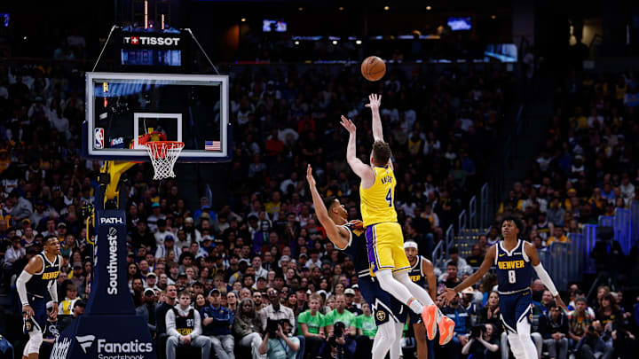 Mar 14, 2025; Denver, Colorado, USA; Los Angeles Lakers guard Dalton Knecht (4) attempts a shot as Denver Nuggets forward Michael Porter Jr. (1) guards in the second quarter at Ball Arena. Mandatory Credit: Isaiah J. Downing-Imagn Images