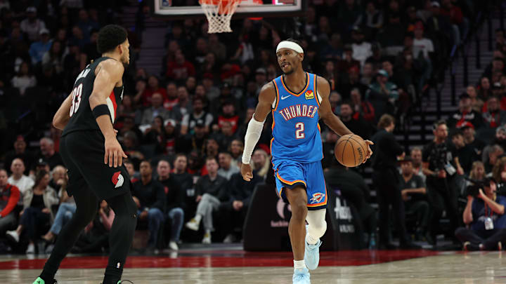 Nov 5, 2025; Portland, Oregon, USA;  Oklahoma City Thunder guard Shai Gilgeous-Alexander (2) dribbles the ball up the court against Portland Trail Blazers forward Toumani Camara (33) during the first half at Moda Center. Mandatory Credit: Jaime Valdez-Imagn Images

