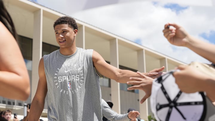 Jun 28, 2025; San Antonio, TX, USA; San Antonio Spurs first round draft pick Carter Bryant greets fans at Victory Capital Performance Center. Mandatory Credit: Scott Wachter-Imagn Images