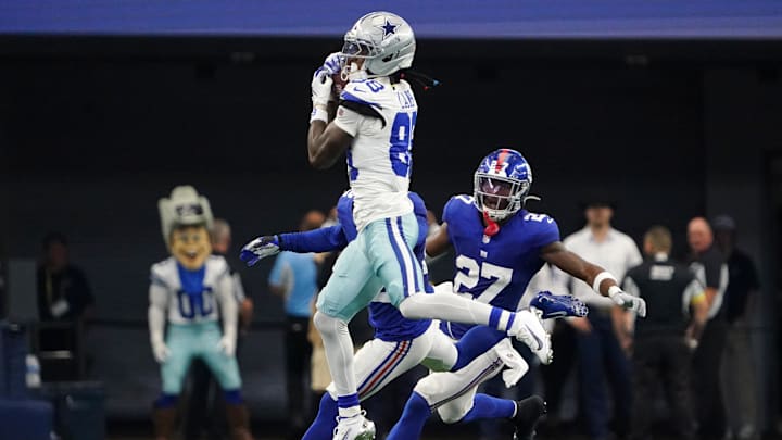 Sep 14, 2025; Arlington, Texas, USA; Dallas Cowboys wide receiver CeeDee Lamb (88) makes a catch against New York Giants safety Tyler Nubin (27) during the fourth quarter at AT&T Stadium. Mandatory Credit: Raymond Carlin III-Imagn Images