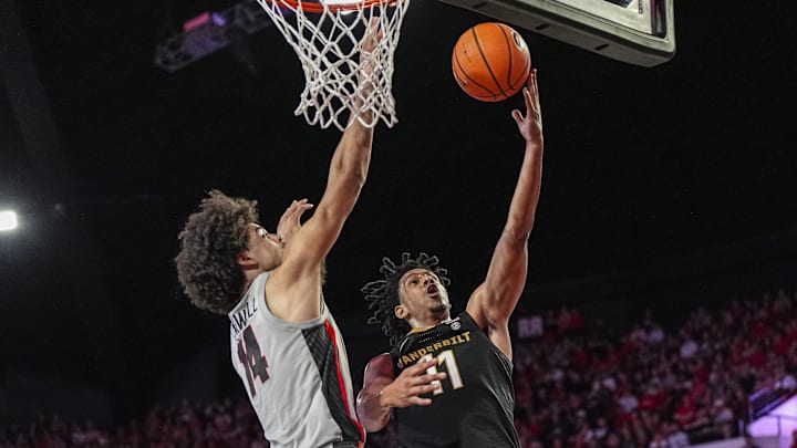 Mar 8, 2025; Athens, Georgia, USA; Vanderbilt Commodores guard AJ Hoggard (11) goes to the basket against Georgia Bulldogs forward Asa Newell (14) during the second half at Stegeman Coliseum. Mandatory Credit: Dale Zanine-Imagn Images