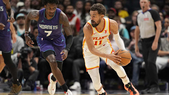 Mar 18, 2025; Charlotte, North Carolina, USA; Atlanta Hawks guard Trae Young (11) handles the ball against Charlotte Hornets guard Damion Baugh (7) during second quarter at Spectrum Center. Mandatory Credit: Jim Dedmon-Imagn Images