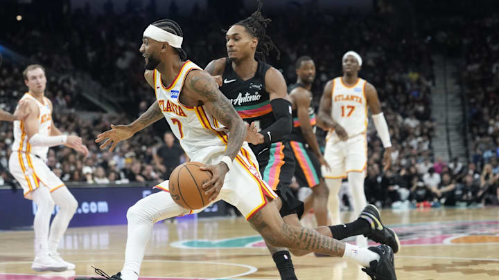 Nov 20, 2025; San Antonio, Texas, USA; Atlanta Hawks guard Nickeil Alexander-Walker (7) drives to the basket past San Antonio Spurs guard Devin Vassell (24) during the second half at Frost Bank Center. Mandatory Credit: Scott Wachter-Imagn Images