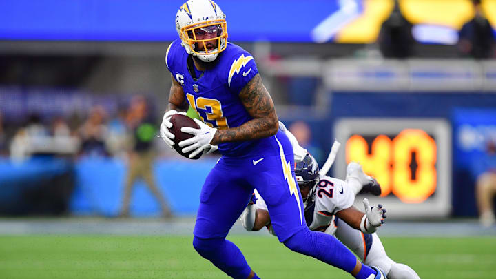 Dec 10, 2023; Inglewood, California, USA; Los Angeles Chargers wide receiver Keenan Allen (13) runs the ball ahead of Denver Broncos cornerback Ja'Quan McMillian (29) during the first half at SoFi Stadium. Mandatory Credit: Gary A. Vasquez-Imagn Images