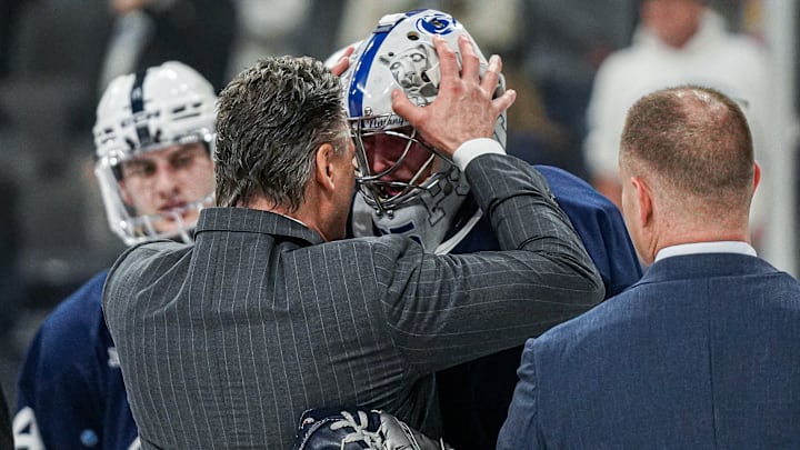 Penn State men's hockey coach Guy Gadowsky congratulates goaltender Arsenii Sergeev after the Nittany Lions' win over UConn in the NCAA Tournament Allentown Regional final.