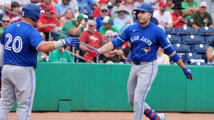 Mar 17, 2024; Clearwater, Florida, USA; Toronto Blue Jays infielder Joey Votto (37) is congratulated after hitting a home run against the Philadelphia Phillies during the first inning at BayCare Ballpark.