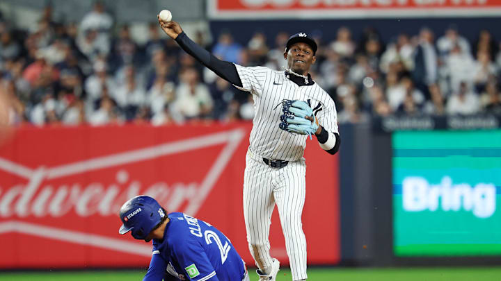 Oct 8, 2025; Bronx, New York, USA; New York Yankees second baseman Jazz Chisholm Jr. (13) forces out Toronto Blue Jays third baseman Ernie Clement (22) and tries to turn a double play during the eighth inning during game four of the ALDS round for the 2025 MLB playoffs at Yankee Stadium. Mandatory Credit: Vincent Carchietta-Imagn Images Oct 8, 2025; Bronx, New York, USA; New York Yankees second baseman Jazz Chisholm Jr. (13) forces out Toronto Blue Jays third baseman Ernie Clement (22) and tries to turn a double play during the eighth inning during game four of the ALDS round for the 2025 MLB playoffs at Yankee Stadium. Mandatory Credit: Vincent Carchietta-Imagn Images