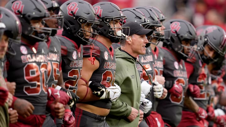 Oklahoma coach Brent Venables walks with his team before OU's contest against Missouri.