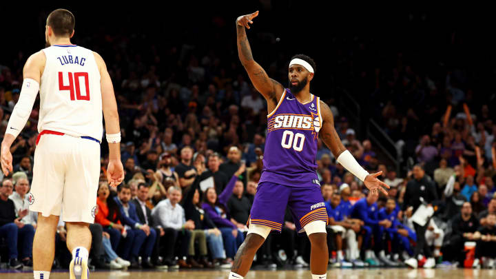 Apr 9, 2024; Phoenix, Arizona, USA;  Phoenix Suns forward Royce O'Neale (00) celebrates after a play against LA Clippers center Ivica Zubac (40) during the fourth quarter at Footprint Center. Mandatory Credit: Mark J. Rebilas-USA TODAY Sports