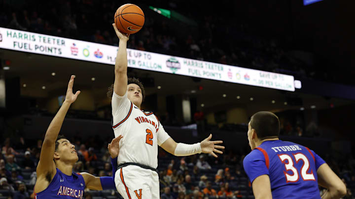 Dec 22, 2025; Charlottesville, Virginia, USA; Virginia Cavaliers guard Chance Mallory (2) shoots the ball over American University Eagles forward Julen Iturbe (32) and Eagles forward Greg Jones (23) /dc2h/ at John Paul Jones Arena. Mandatory Credit: Geoff Burke-Imagn Images