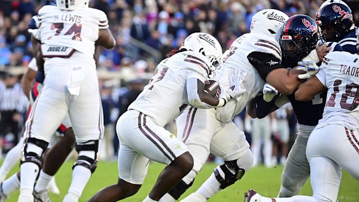 Nov 29, 2024; Oxford, Mississippi, USA; Mississippi State Bulldogs running back Davon Booth (21) runs the ball against the Mississippi Rebels during the second quarter at Vaught-Hemingway Stadium. Mandatory Credit: Matt Bush-Imagn Images Nov 29, 2024; Oxford, Mississippi, USA; Mississippi State Bulldogs running back Davon Booth (21) runs the ball against the Mississippi Rebels during the second quarter at Vaught-Hemingway Stadium. Mandatory Credit: Matt Bush-Imagn Images