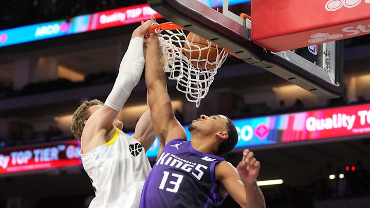 Dec 8, 2024; Sacramento, California, USA; Utah Jazz forward Lauri Markkanen (left) dunks against Sacramento Kings forward Keegan Murray (13) during the third quarter at Golden 1 Center. Mandatory Credit: Darren Yamashita-Imagn Images