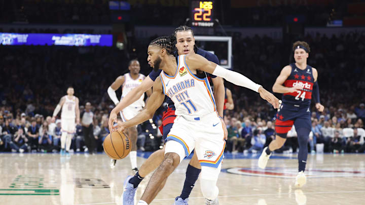 Dec 23, 2024; Oklahoma City, Oklahoma, USA;Oklahoma City Thunder guard Isaiah Joe (11) steals the ball away from Washington Wizards forward Kyshawn George (18) during the second quarter at Paycom Center. Mandatory Credit: Alonzo Adams-Imagn Images