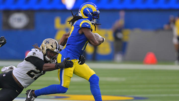 Nov 2, 2025; Inglewood, California, USA; Los Angeles Rams wide receiver Davante Adams (17) runs after the catch as New Orleans Saints safety Justin Reid (21) attempts to make the tackle during the second half at SoFi Stadium. Mandatory Credit: Jayne Kamin-Oncea-Imagn Images