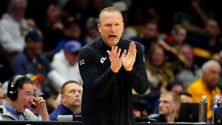 Jan 12, 2025; Boulder, Colorado, USA; West Virginia Mountaineers head coach Darian DeVries claps in the second half against the Colorado Buffaloes at CU Events Center. Mandatory Credit: Ron Chenoy-Imagn Images