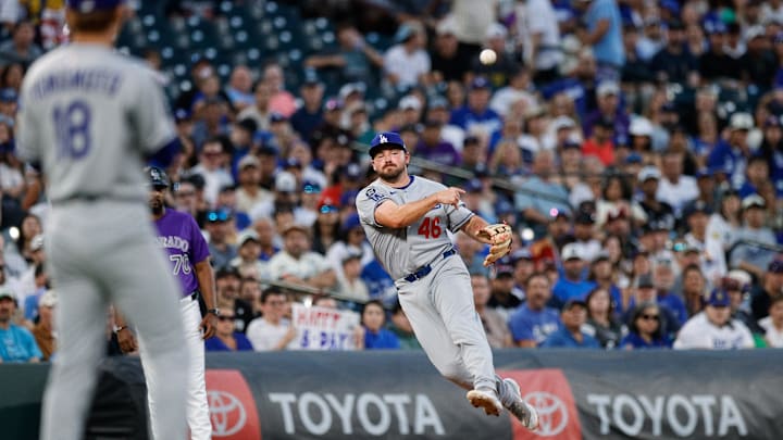 Aug 18, 2025; Denver, Colorado, USA; Los Angeles Dodgers third baseman Buddy Kennedy (46) makes a throw to first for an out in the fourth inning against the Colorado Rockies at Coors Field. Mandatory Credit: Isaiah J. Downing-Imagn Images