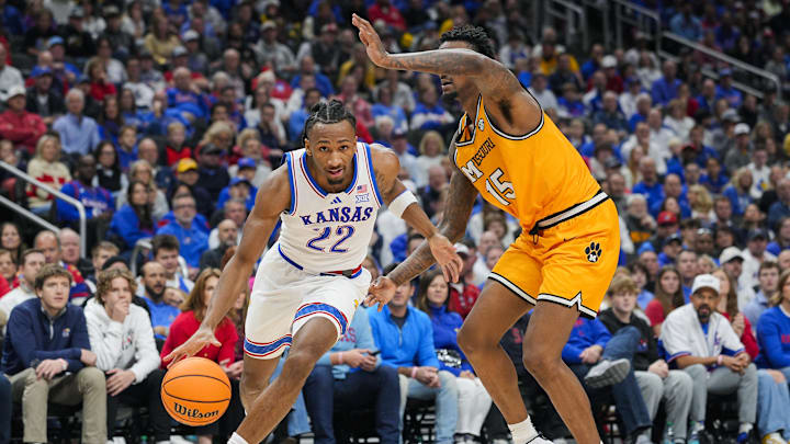 Dec 7, 2025; Kansas City, Missouri, USA; Kansas Jayhawks guard Darryn Peterson (22) drives against Missouri Tigers center Shawn Phillips Jr. (15) during the first half at T-Mobile Center. Mandatory Credit: Jay Biggerstaff-Imagn Images