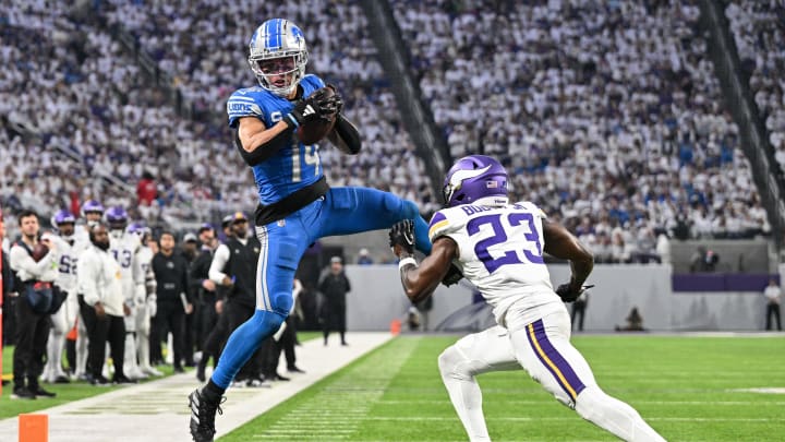 Dec 24, 2023; Minneapolis, Minnesota, USA; Detroit Lions wide receiver Amon-Ra St. Brown (14) catches a pass as Minnesota Vikings cornerback Andrew Booth Jr. (23) defends during the game at U.S. Bank Stadium. 
