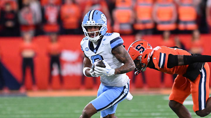Oct 31, 2025; Syracuse, New York, USA; North Carolina Tar Heels wide receiver Kobe Paysour (8) runs past Syracuse Orange defensive back Demetres Samuel Jr. (1) after making a catch in the first quarter at the JMA Wireless Dome. 
