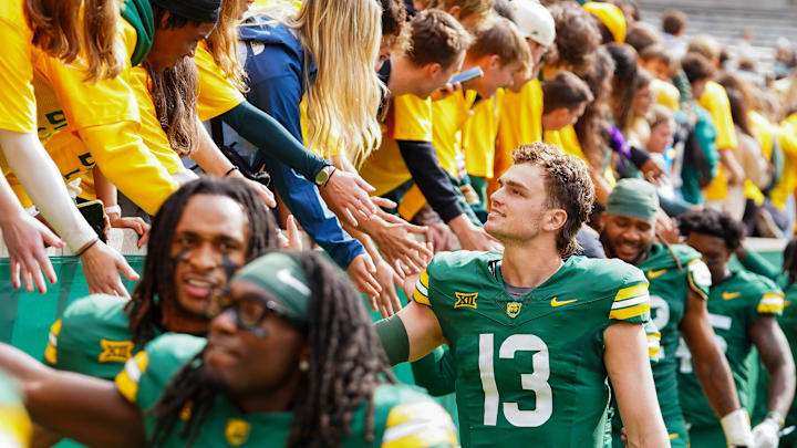 Baylor Bears quarterback Sawyer Robertson (13) high fives the fans in the student section following a game against the UCF Knights at McLane Stadium