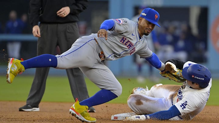Oct 13, 2024; Los Angeles, California, USA; New York Mets shortstop Francisco Lindor (12) gets the tag on Los Angeles Dodgers two-way player Shohei Ohtani (17) attempting to steal second base in the second inning during game one of the NLCS for the 2024 MLB Playoffs at Dodger Stadium. Mandatory Credit: Jayne Kamin-Oncea-Imagn Images Oct 13, 2024; Los Angeles, California, USA; New York Mets shortstop Francisco Lindor (12) gets the tag on Los Angeles Dodgers two-way player Shohei Ohtani (17) attempting to steal second base in the second inning during game one of the NLCS for the 2024 MLB Playoffs at Dodger Stadium. Mandatory Credit: Jayne Kamin-Oncea-Imagn Images
