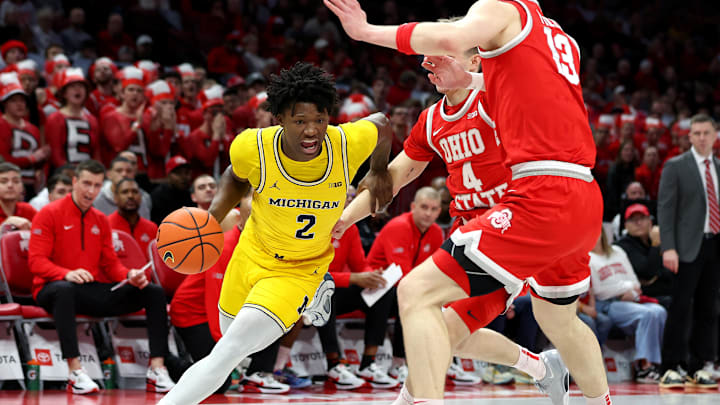 Feb 8, 2026; Columbus, Ohio, USA;  Michigan Wolverines guard L.J. Cason (2) drives to the basket as Ohio State Buckeyes center Christoph Tilly (13) defends during the first half at Value City Arena. Mandatory Credit: Joseph Maiorana-Imagn Images
