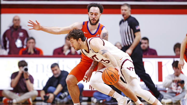 Jan 25, 2025; Blacksburg, Virginia, USA; Virginia Tech Hokies forward Ben Burnham (13) drives to the basket against Clemson Tigers guard Jaeden Zackery (11) during the second half at Cassell Coliseum. Mandatory Credit: Peter Casey-Imagn Images Jan 25, 2025; Blacksburg, Virginia, USA; Virginia Tech Hokies forward Ben Burnham (13) drives to the basket against Clemson Tigers guard Jaeden Zackery (11) during the second half at Cassell Coliseum. Mandatory Credit: Peter Casey-Imagn Images