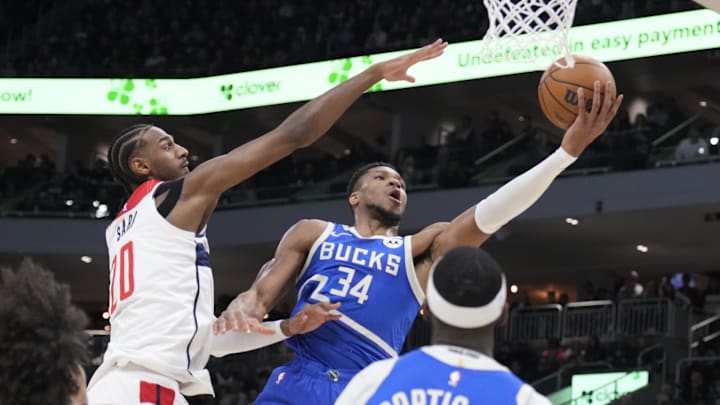 Nov 30, 2024; Milwaukee, Wisconsin, USA; Milwaukee Bucks forward Giannis Antetokounmpo (34) drives to the basket against Washington Wizards forward Alexandre Sarr (20) in the first half at Fiserv Forum. Mandatory Credit: Michael McLoone-Imagn Images