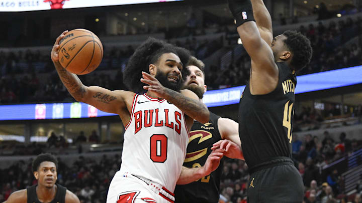 Chicago Bulls guard Coby White (0) drives past Cleveland Cavaliers guard Donovan Mitchell (45) during the first half at the  United Center. Mandatory Credit: Matt Marton-Imagn Images