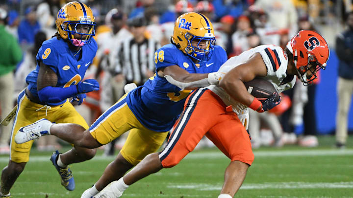 Oct 24, 2024; Pittsburgh, Pennsylvania, USA; Pittsburgh Panthers linebacker Keye Thompson (38) tackles Syracuse Orange tight end Oronde Gadsden II (19) during the second quarter  at Acrisure Stadium. Mandatory Credit: Barry Reeger-Imagn Images
