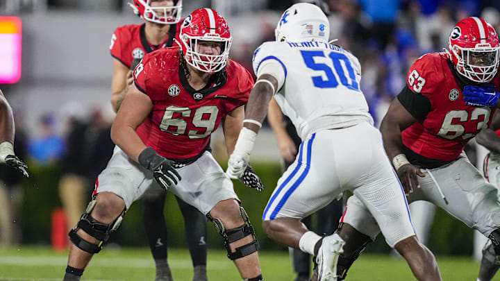 Georgia Bulldogs offensive lineman Tate Ratledge (69) blocks against Kentucky Wildcats defensive lineman Darrion Henry-Young (50)