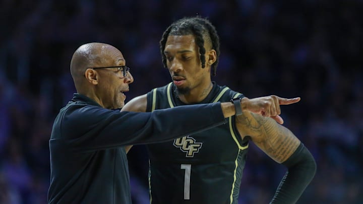 Jan 6, 2024; Manhattan, Kansas, USA; UCF Knights head coach Johnny Dawkins talks to guard Antwann