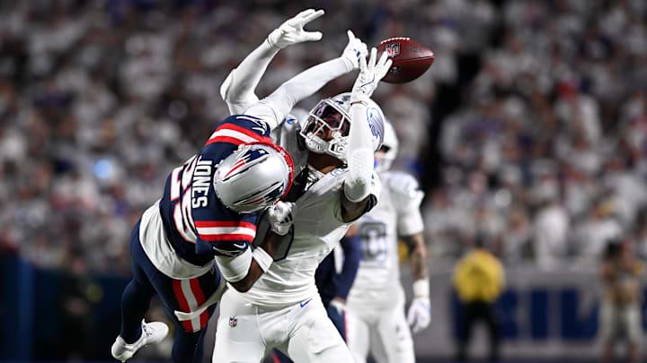 Oct 5, 2025; Orchard Park, New York, USA; Buffalo Bills wide receiver Keon Coleman (0) attempts to make a catch over New England Patriots cornerback Marcus Jones (25) during the first half at Highmark Stadium. Mandatory Credit: Mark Konezny-Imagn Images