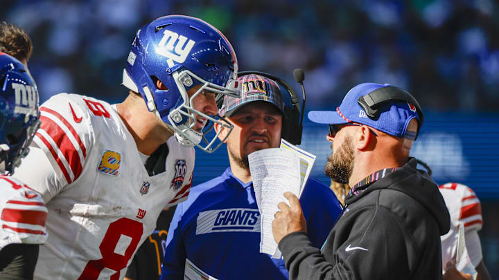Oct 6, 2024; Seattle, Washington, USA; New York Giants quarterback Daniel Jones (8) talks with head coach Brian Daboll, right) during the second quarter against the Seattle Seahawks at Lumen Field. New York Giants quarterbacks coach Shea Tierney stands in the middle.  