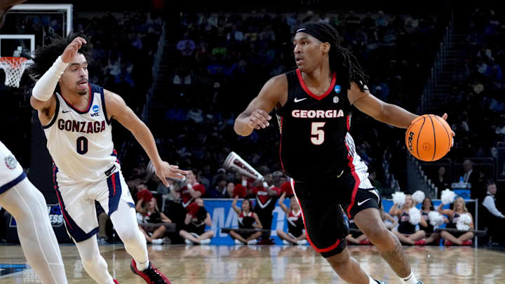 Mar 20, 2025; Wichita, KS, USA; Georgia Bulldogs guard Silas Demary Jr. (5) dribbles against Gonzaga Bulldogs guard Ryan Nembhard (0) in the first half of a first round men’s NCAA Tournament game at Intrust Bank Arena. Mandatory Credit: Kirby Lee-Imagn Images