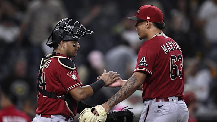 Aug 19, 2023; San Diego, California, USA; Arizona Diamondbacks catcher Gabriel Moreno (14) and relief pitcher Justin Martinez (63) celebrate after defeating the San Diego Padres at Petco Park. Mandatory Credit: Orlando Ramirez-Imagn Images Aug 19, 2023; San Diego, California, USA; Arizona Diamondbacks catcher Gabriel Moreno (14) and relief pitcher Justin Martinez (63) celebrate after defeating the San Diego Padres at Petco Park. Mandatory Credit: Orlando Ramirez-Imagn Images