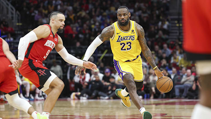 Jan 29, 2024; Houston, Texas, USA; Los Angeles Lakers forward LeBron James (23) dribbles the ball as Houston Rockets forward Dillon Brooks (9) defends during the fourth quarter at Toyota Center. Mandatory Credit: Troy Taormina-Imagn Images