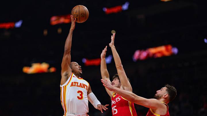 Oct 24, 2026; Atlanta, Georgia, USA;  Atlanta Hawks guard CJ McCollum (3) shoots over Houston Rockets guard Reed Sheppard (15) and Houston Rockets center Alperen Sengun (28) in the first quarter at State Farm Arena.  Mandatory Credit: Colin Hubbard-Imagn Images