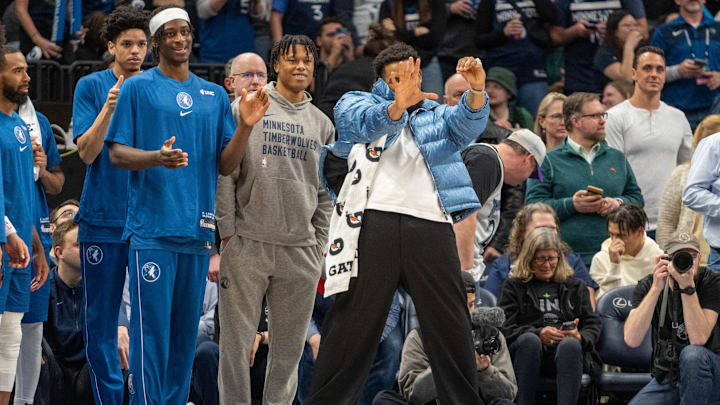 Minnesota Timberwolves center Karl-Anthony Towns (32) reacts after guard Anthony Edwards (5) scores against the Washington Wizards in the fourth quarter at Target Center in Minneapolis on April 9, 2024.