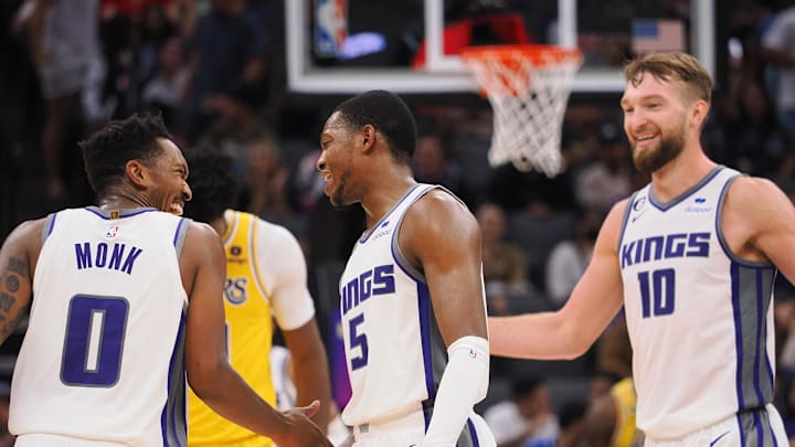 Oct 14, 2022; Sacramento, California, USA; Sacramento Kings shooting guard Malik Monk (0) celebrates with Sacramento Kings point guard De'Aaron Fox (5) and power forward Domantas Sabonis (10) after a basket against the Los Angeles Lakers during the third quarter at Golden 1 Center. Mandatory Credit: Kelley L Cox-Imagn Images