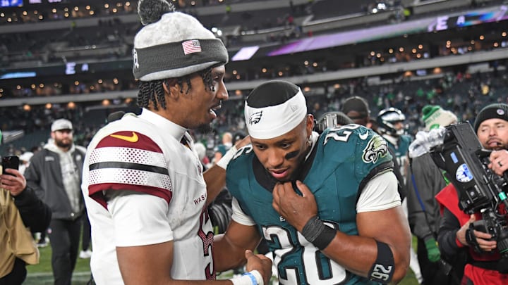 Nov 14, 2024; Philadelphia, Pennsylvania, USA; Washington Commanders quarterback Jayden Daniels (5) and Philadelphia Eagles running back Saquon Barkley (26) meet on the field after the game at Lincoln Financial Field. Mandatory Credit: Eric Hartline-Imagn Images
