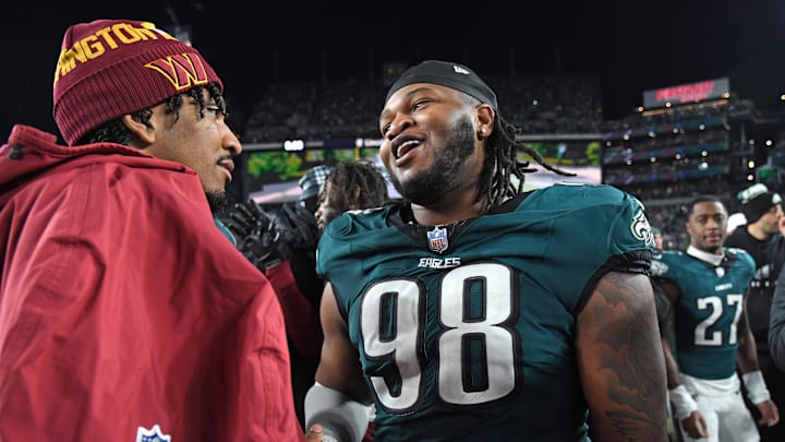 Jan 26, 2025; Philadelphia, PA, USA; Washington Commanders quarterback Jayden Daniels (5) and Philadelphia Eagles defensive tackle Jalen Carter (98) after the NFC Championship game at Lincoln Financial Field. Mandatory Credit: Eric Hartline-Imagn Images