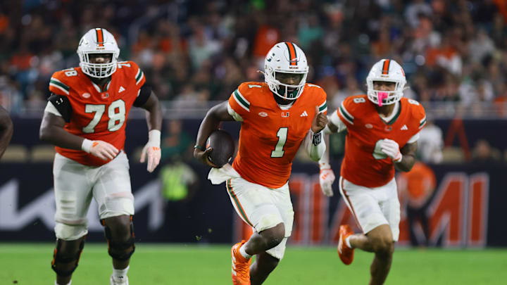 Sep 27, 2024; Miami Gardens, Florida, USA; Miami Hurricanes quarterback Cam Ward (1) runs with the football against the Virginia Tech Hokies during the third quarter at Hard Rock Stadium. Mandatory Credit: Sam Navarro-Imagn Images