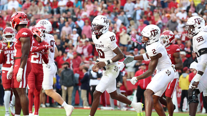 Oct 18, 2025; Fayetteville, Arkansas, USA; Texas A&M Aggies quarterback Marcel Reed (10) celebrates after scoring a touchdown in the second quarter against the Arkansas Razorbacks at Donald W. Reynolds Razorback Stadium. Mandatory Credit: Nelson Chenault-Imagn Images