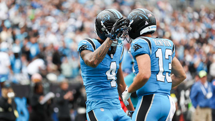 Oct 12, 2025; Charlotte, North Carolina, USA; Carolina Panthers wide receiver Tetairoa McMillan (4) celebrates a touchdown during the second half the Dallas Cowboys at Bank of America Stadium. Mandatory Credit: Cory Knowlton-Imagn Images Oct 12, 2025; Charlotte, North Carolina, USA; Carolina Panthers wide receiver Tetairoa McMillan (4) celebrates a touchdown during the second half the Dallas Cowboys at Bank of America Stadium. Mandatory Credit: Cory Knowlton-Imagn Images
